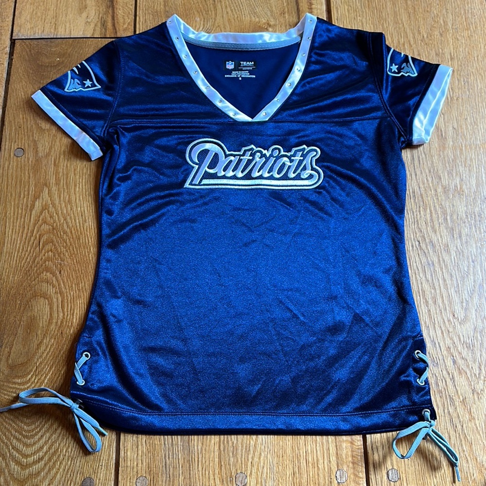 Patriots NFL Team Apparel silky, lace-up and rhinestone accented fan top.